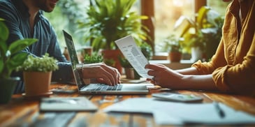 a person's hands on a laptop