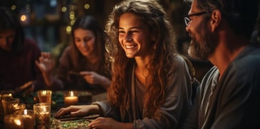 a person smiling at a table with people around it