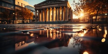 a building with columns and a building in the background