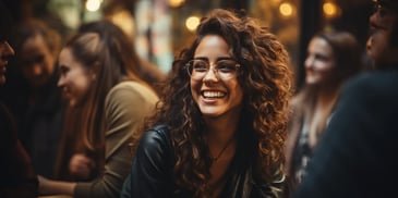 a person smiling with curly hair