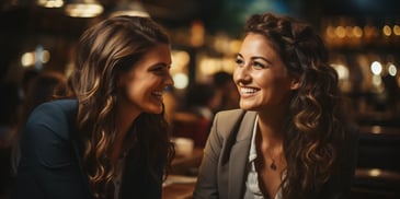 two women smiling at each other