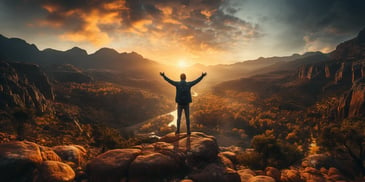 a person standing on a rock with their arms raised