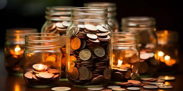 a group of glass jars filled with coins