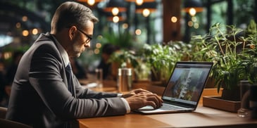 a person in a suit and tie working on a laptop