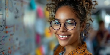 Smiling woman with glasses in office.