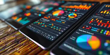 Digital tablets displaying colorful data charts.