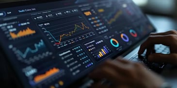 Hands typing on laptop displaying analytics.
