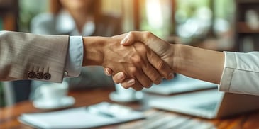 Two people shaking hands in agreement.