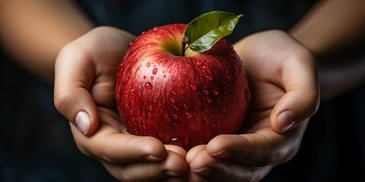 a person holding an apple