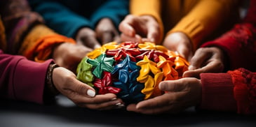 hands holding a colorful object with ribbons