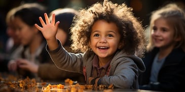 a child waving and smiling