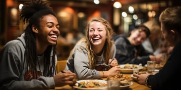 a group of people sitting at a table smiling