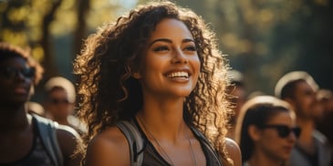 a person smiling with curly hair
