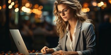 a person in glasses working on a laptop