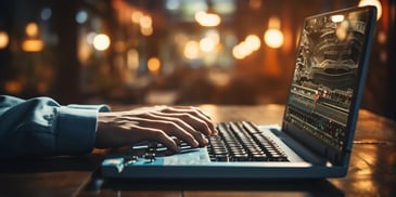 a person's hands on a laptop